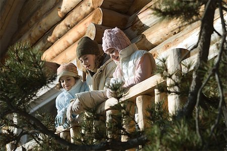 simsearch:695-03388794,k - Three preteen or teen girls standing on deck of log cabin, looking away, low angle view Stock Photo - Premium Royalty-Free, Code: 695-03377332