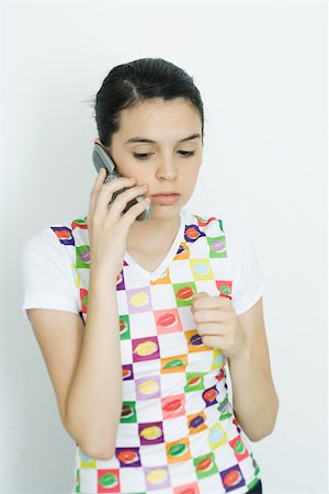 simsearch:640-03260747,k - Teenage girl holding up cell phone, looking down Stock Photo - Premium Royalty-Free, Code: 695-03377351