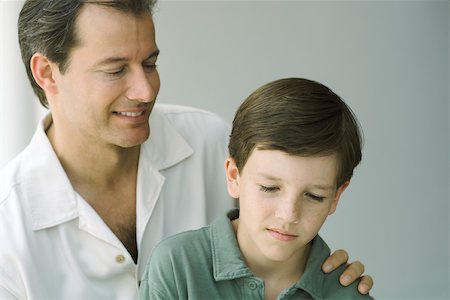simsearch:695-03378605,k - Father and son looking down and smiling together, close-up Stock Photo - Premium Royalty-Free, Code: 695-03377494