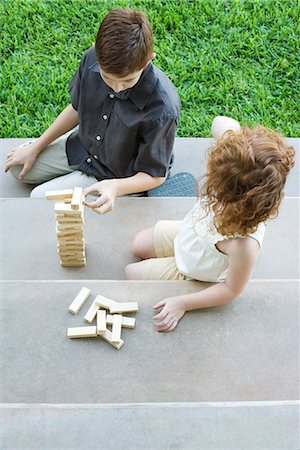 Brother and sister playing with blocks on steps, high angle view Stock Photo - Premium Royalty-Free, Code: 695-03378014