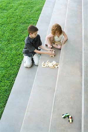 Brother and sister playing with blocks on steps, high angle view Stock Photo - Premium Royalty-Free, Code: 695-03378013