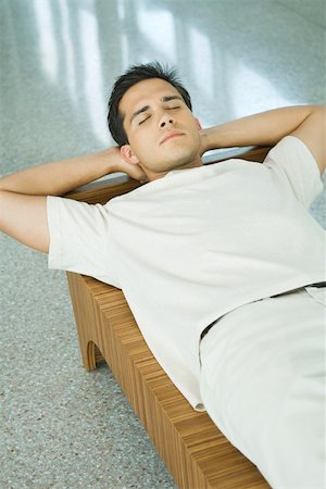 daydreamer (male) - Young man lying on bench with hands behind head, eyes closed Stock Photo - Premium Royalty-Free, Code: 695-03378525