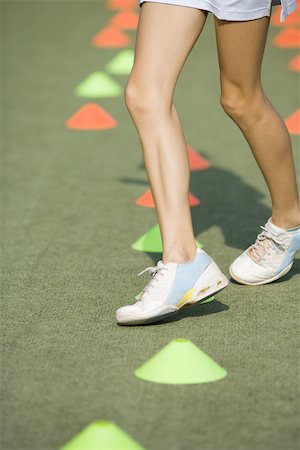 simsearch:695-03378125,k - Teenage girl running through plastic cones, low angle view, cropped Stock Photo - Premium Royalty-Free, Code: 695-03378565
