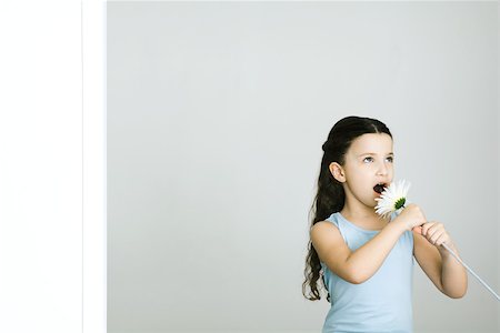 simsearch:632-01193783,k - Little girl singing into flower, looking away Stock Photo - Premium Royalty-Free, Code: 695-03378597