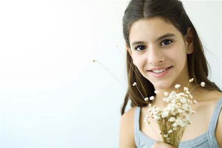 simsearch:400-05697219,k - Teenage girl holding flower bouquet, smiling at camera, portrait Stock Photo - Premium Royalty-Free, Code: 695-03378824