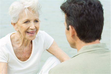 forty wrinkle - Senior woman sitting across from man, smiling Stock Photo - Premium Royalty-Free, Code: 695-03378990