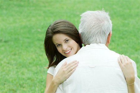 Teen girl embracing grandfather, smiling at camera Foto de stock - Sin royalties Premium, Código: 695-03379437