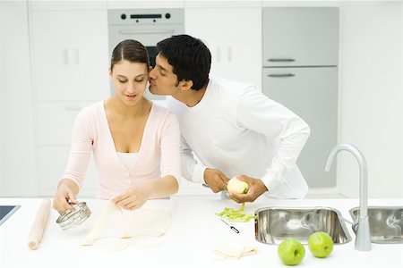 Couple cooking together, man kissing woman's cheek Foto de stock - Sin royalties Premium, Código: 695-03379482