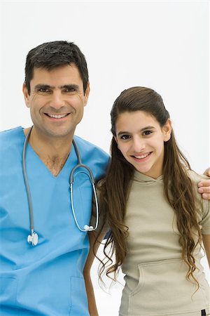 simsearch:400-05697219,k - Doctor with arm around preteen girl's shoulder, both smiling at camera Stock Photo - Premium Royalty-Free, Code: 695-03379563