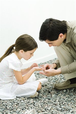 simsearch:633-05401710,k - Father and daughter looking at gravel together Stock Photo - Premium Royalty-Free, Code: 695-03379623