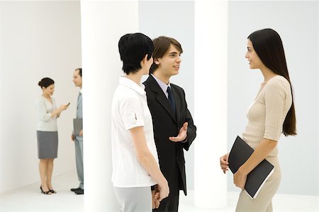 Young businessman introducing two business women to each other, smiling at each other Stock Photo - Premium Royalty-Free, Code: 695-03379874