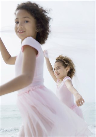 Two girls running on beach Stock Photo - Premium Royalty-Free, Code: 695-03373640
