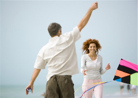 Couple with kite on beach Stock Photo - Premium Royalty-Free, Code: 695-03373669