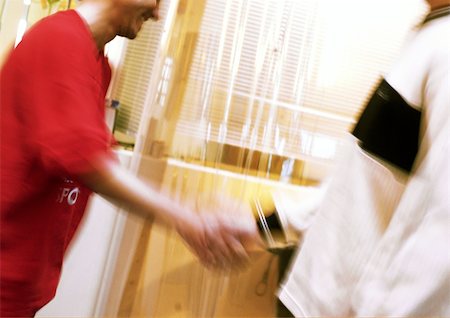 simsearch:640-03262464,k - Two people shaking hands, blurred motion Stock Photo - Premium Royalty-Free, Code: 695-03384183
