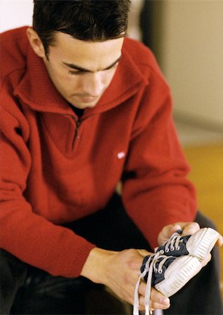 dreading - Man looking at child's shoes Stock Photo - Premium Royalty-Free, Code: 695-03384761