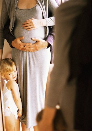 simsearch:400-04866555,k - Hands on pregnant woman's stomach, child standing next to woman Foto de stock - Sin royalties Premium, Código: 695-03384786