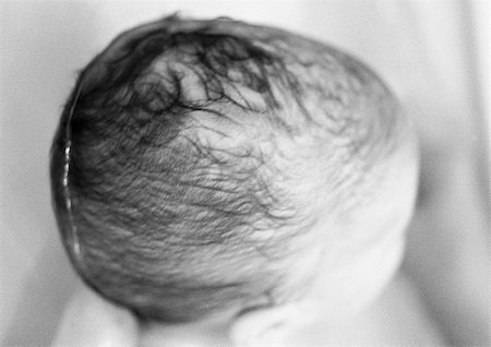 Baby's wet head, high angle view, close-up, b&w Stock Photo - Premium Royalty-Free, Code: 695-03384911