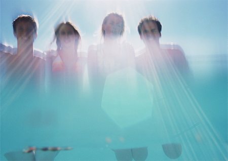 family abstract - Two men and two women, low angle view, shot from underwater Stock Photo - Premium Royalty-Free, Code: 695-03385121