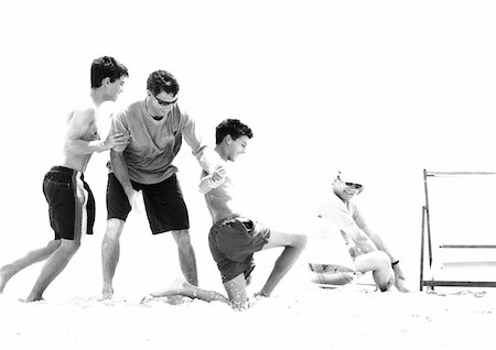 Family playing on beach, b&w Stock Photo - Premium Royalty-Free, Code: 695-03385216