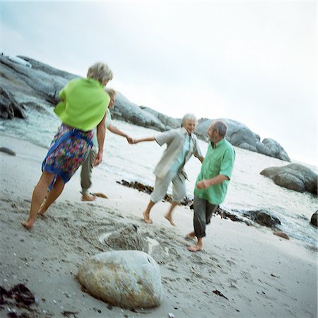 Mature group playing on beach Stock Photo - Premium Royalty-Free, Code: 695-03386184