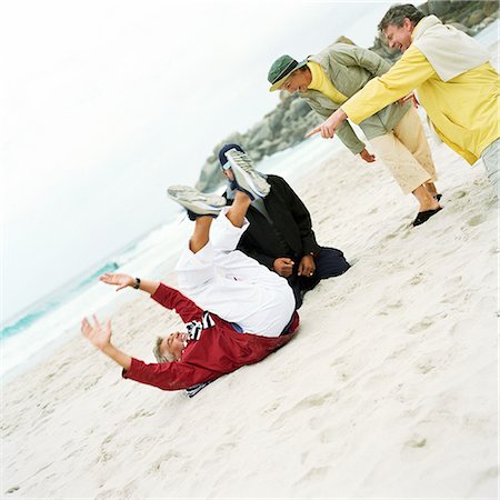 Mature group playing on beach Stock Photo - Premium Royalty-Free, Code: 695-03386181