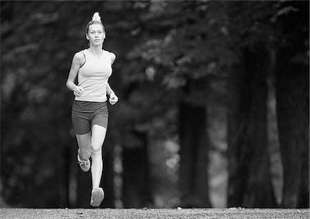 simsearch:633-01715682,k - Woman running, trees in background, b&w Stock Photo - Premium Royalty-Free, Code: 695-03386400