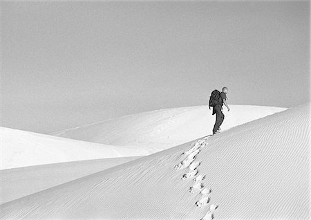 dune driving - Man hiking across dune, side view, b&w Stock Photo - Premium Royalty-Free, Code: 695-03386402
