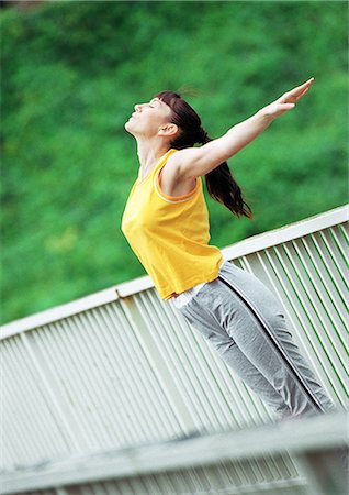 simsearch:695-05768377,k - Woman doing stretching exercises on bridge, tilt Stock Photo - Premium Royalty-Free, Code: 695-03386415