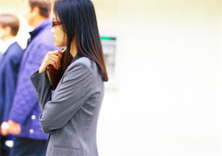 Businesswoman holding book, side view Foto de stock - Sin royalties Premium, Código: 695-03386796