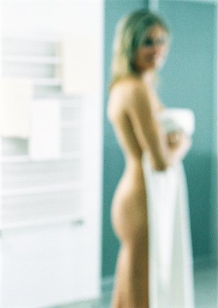 Nude woman standing with bath towel, blurred, portrait. Stock Photo - Premium Royalty-Free, Code: 695-03387030