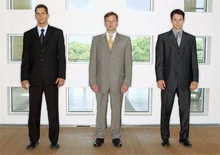 simsearch:700-05662619,k - Three businessmen standing in a line Stock Photo - Premium Royalty-Free, Code: 695-03387257