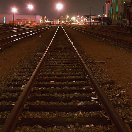Train tracks in railyard at night Stock Photo - Premium Royalty-Free, Code: 695-03387304