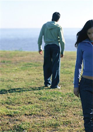 simsearch:632-01148228,k - Young couple walking away from one another Stock Photo - Premium Royalty-Free, Code: 695-03387516