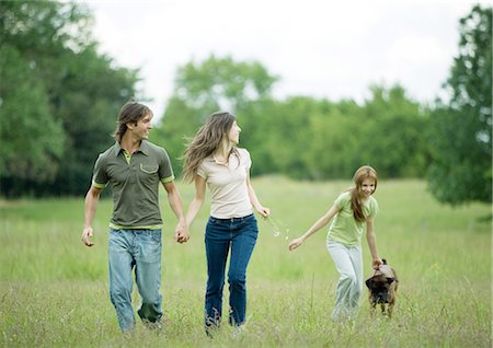 simsearch:400-03934248,k - Young adult couple walking with girl and dog Stock Photo - Premium Royalty-Free, Code: 695-03388499