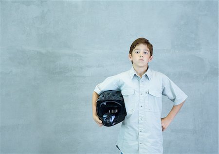 Boy standing with helmet under arm Stock Photo - Premium Royalty-Free, Code: 695-03388770