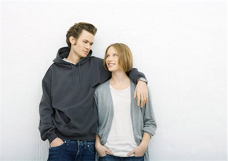 simsearch:640-03259938,k - Young couple, man with arm around woman's shoulder, woman looking up at him Stock Photo - Premium Royalty-Free, Code: 695-03388929
