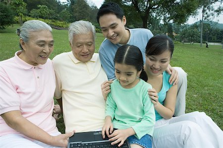 simsearch:6116-06939008,k - Three generation family, using laptop in park Stock Photo - Premium Royalty-Free, Code: 695-03388966