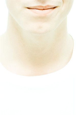 Young man, cropped view, lower face and neck, close-up Stock Photo - Premium Royalty-Free, Code: 695-03389134