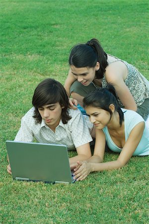 simsearch:633-01715612,k - Group of young friends lying in grass using laptop Stock Photo - Premium Royalty-Free, Code: 695-03389173