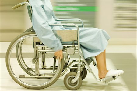 simsearch:632-01613036,k - Cropped view of man using wheelchair, dressed in hospital gown, blurred motion Stock Photo - Premium Royalty-Free, Code: 695-03389306