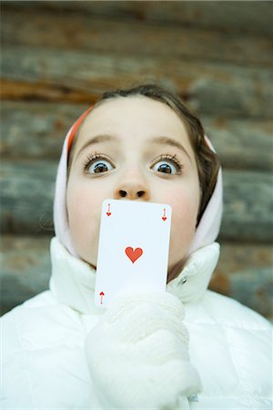 simsearch:695-03376367,k - Girl holding card over mouth, dressed in winter clothing, looking at camera, wide eyes Stock Photo - Premium Royalty-Free, Code: 695-03389370