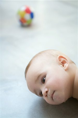 simsearch:614-06043612,k - Baby lying on floor, head, close-up Stock Photo - Premium Royalty-Free, Code: 695-03389385