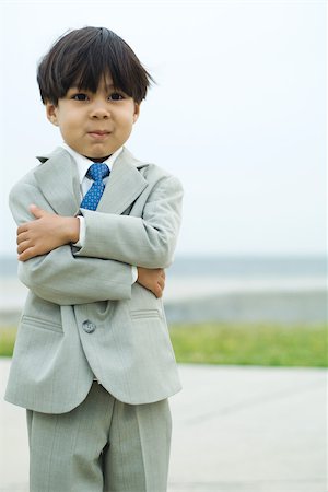 simsearch:632-01193783,k - Young boy dressed in suit, arms folded, smiling, portrait Stock Photo - Premium Royalty-Free, Code: 695-03389714