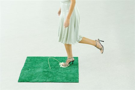 simsearch:695-03378125,k - Woman stepping on flower in square of artificial turf, waist down Stock Photo - Premium Royalty-Free, Code: 695-03389744