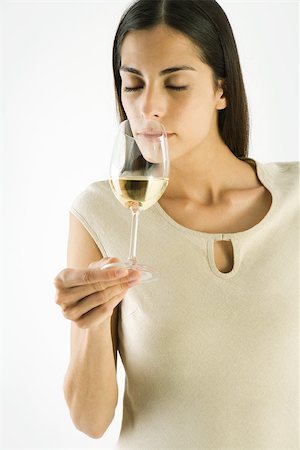 Woman smelling glass of white wine, eyes closed Stock Photo - Premium Royalty-Free, Code: 695-03389889