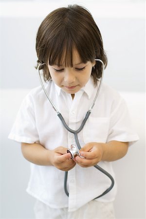 simsearch:632-03027302,k - Little boy playing with stethoscope, looking down Stock Photo - Premium Royalty-Free, Code: 695-03389915