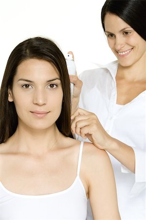 Woman getting her hair done, looking at camera Stock Photo - Premium Royalty-Free, Code: 695-03389952