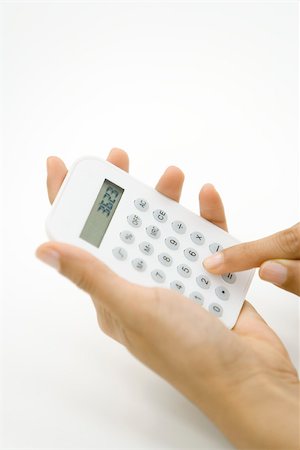 Person using calculator, cropped view of hands Stock Photo - Premium Royalty-Free, Code: 695-03380171