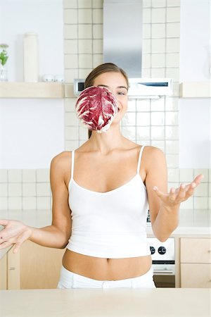 Woman with head of radicchio chicory falling in front of her face Stock Photo - Premium Royalty-Free, Code: 695-03380437