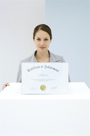 Woman displaying certificate of achievement Stock Photo - Premium Royalty-Free, Code: 695-03380459